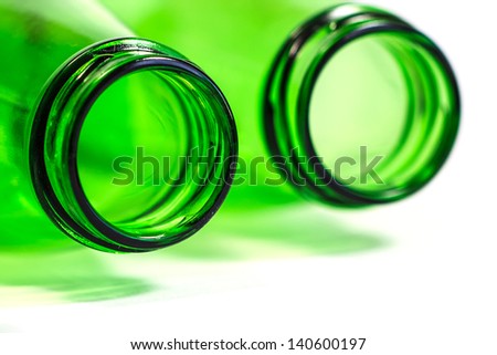 Extra Closeup of Green Bottles Lay Down on White Background with focus on Left bottle, Copy Space Below.