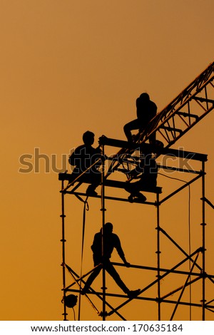 Silhouette of Workmen on assembling concert stage