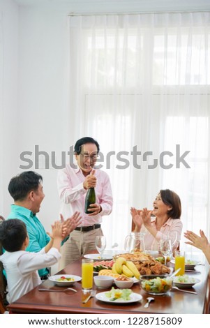 Similar – Foto Bild Älterer Mann öffnet Champagnerflasche während der Weihnachtsfeier zu Hause