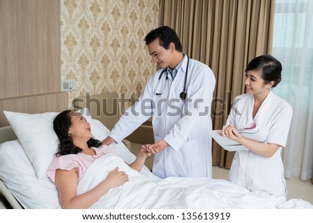 Image of doctors comforting his patient
