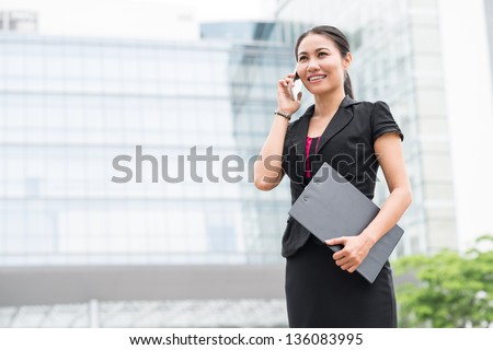 Confident business lady consulting her client by the phone