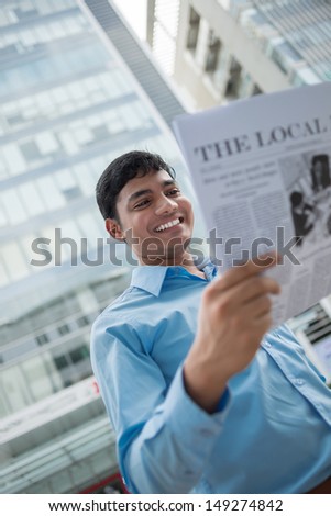 Vertical image of a young businessman being excited with the latest news