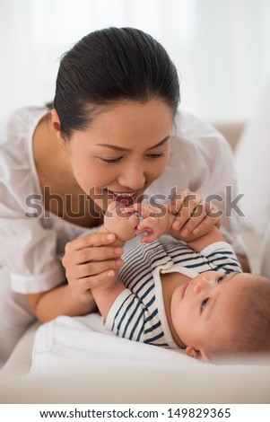 Young woman communicating with her baby