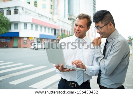 Copy-spaced image of business partners networking outside