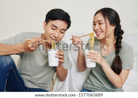 Similar – Image, Stock Photo Young female eating noodles and watching TV