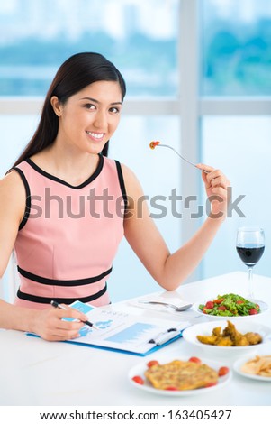 Vertical portrait of a young lady on a business lunch