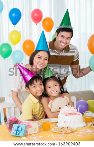 Vertical portrait of a family having a party at home