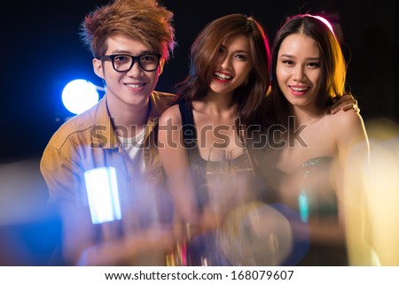 Close up portrait of cheerful youngsters having fun in the night club