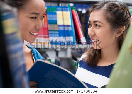 Two girls meeting in library