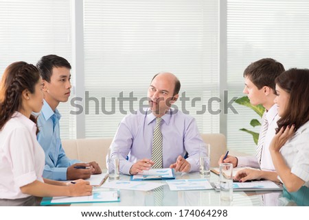 Copy-spaced image of a business team at the meeting with the head of the company