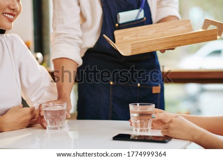 Image, Stock Photo Crop Asian waitress serving burger in cafe