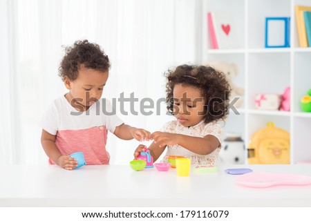 Copy-spaced image of little cute babies playing in the playroom