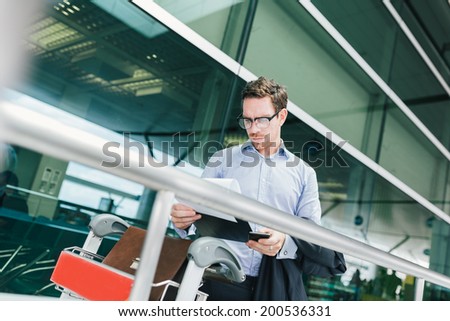 Businessman in glasses reading a customs declaration at the airport