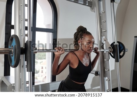 Similar – Image, Stock Photo Serious sportswoman listening to music on stairway