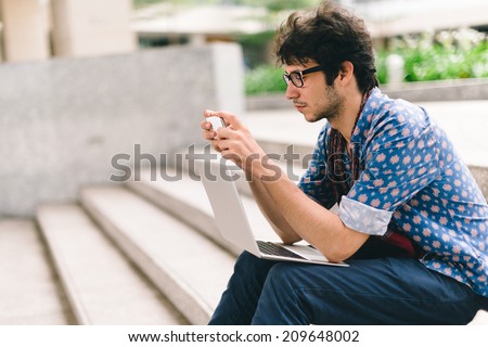 Similar – Foto Bild Ernster Mann, der auf einer Bank im Park auf sein Smartphone schaut