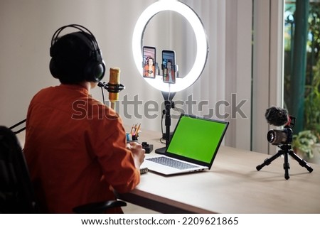 Similar – Image, Stock Photo Young men making video call with phone  while sitting on the sofa at home