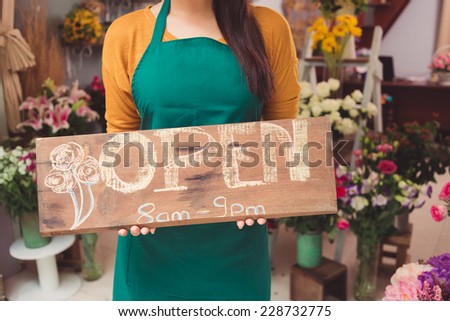 Seller posing with Open sign plate