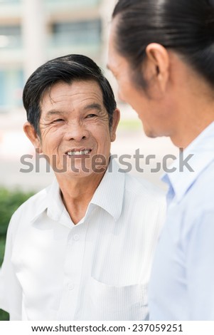 Vietnamese senior man talking to his son