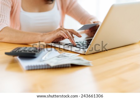 Cropped image of woman paying her bills online, selective focus