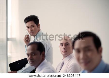 Multi-ethnic group of business people working in the office, selective focus