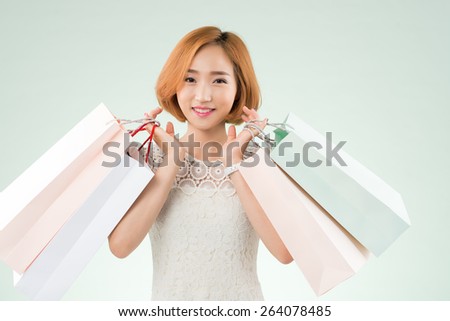 Korean young lady holding shopping bags