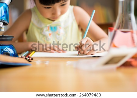Little girl drawing with pencil, selective focus