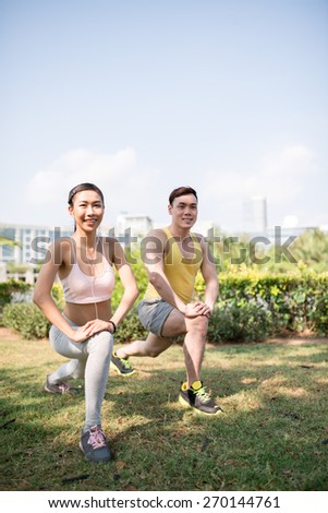 Young Vietnamese couple exercising in the park