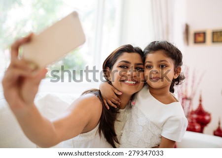 Similar – Image, Stock Photo Happy ethnic mother taking selfie with kid