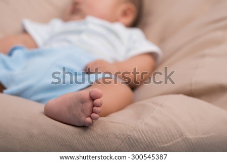 Sweet sleeping infant, focus on little foot