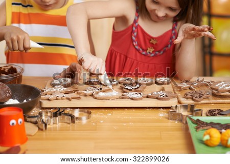 Little girl trying hard to make perfect cookies