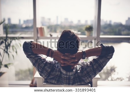 Man relaxing in his chair and enjoying the view from office window Foto stock © 