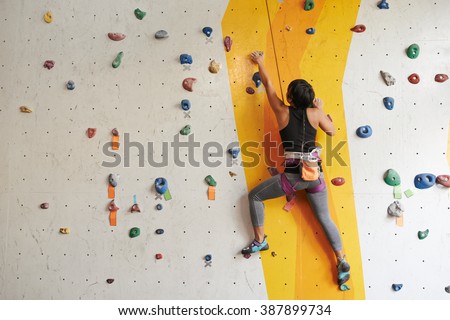 Athletic woman climbing indoors, view from the back Сток-фото © 