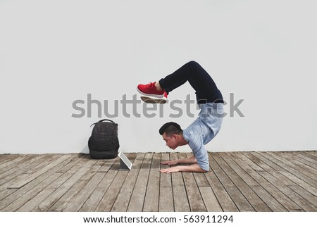 Image, Stock Photo Strong man performing handstand on sports ground