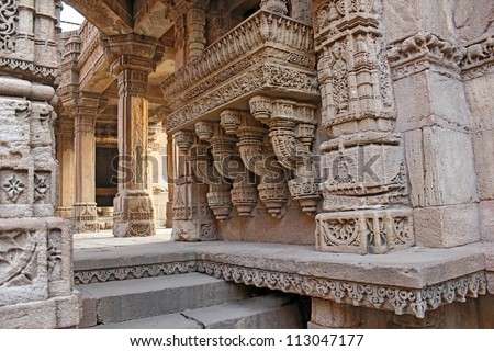 GANDHINAGAR, GUJARAT / INDIA - SEPTEMBER 2 : Adalaj Step Well ( Vav ) on September 2, 2012 in Gandhinagar. Side view of a stone carved balcony. There are 4 such balconies inside the step well.