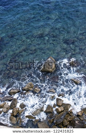 Transparent sea water and stones at the bottom