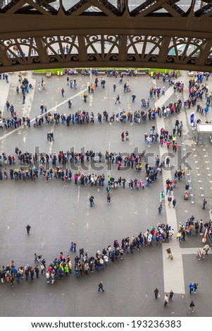 Paris, France, May 2, 2013 . Tourists stand in line at the Eiffel Tower