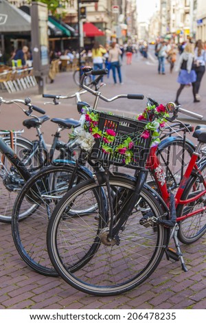 Amsterdam, Netherlands, on July 7, 2014. Bicycle parking on the old narrow city street. The bicycle is very popular type of transport in Holland