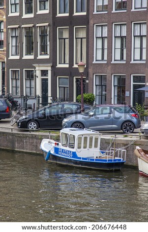 Amsterdam, Netherlands, on July 7, 2014. Typical urban view. Old houses on the bank of the channel