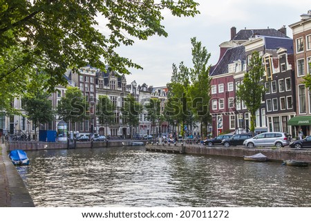 Amsterdam, Netherlands, on July 7, 2014. Typical urban view. Old houses on the bank of the channel