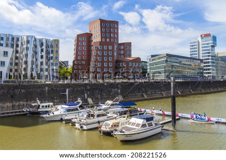 Dusseldorf, Germany, on July 6, 2014. Architectural complex of Rhine Embankment in the area Media harbor and boats at the mooring