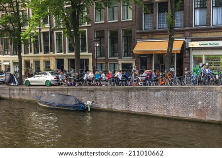 Amsterdam, Netherlands, on July 11, 2014. Typical urban view with houses on the bank of the channel