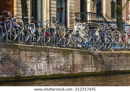 Amsterdam, Netherlands, on July 10, 2014. The bicycles parked on the bank of the channel