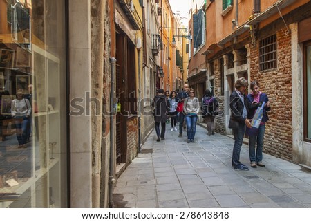 VENICE, ITALY - on APRIL 29, 2015. Pedestrians go on the narrow curve old street