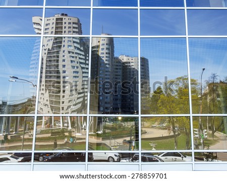 PUSHKINO, RUSSIA - on MAY 7, 2015. The new multystoried house is reflected in a mirror show-window of shopping center