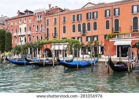 VENICE, ITALY - on APRIL 30, 2015. Ancient buildings on the bank of the Grand channel (Canal Grande). Gondolas at pier. The grand channel is the main transport artery and its most known channel