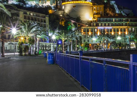 NICE, FRANCE, on MARCH 13, 2015. An English promenade (Promenade des Anglais) in evening lighting. Belland\'s tower (Tour Bellanda). Promenade des Anglais - one of the most beautiful embankments