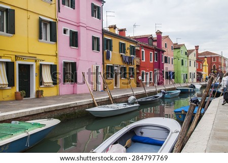 VENICE, ITALY, on APRIL 30, 2015. Multi-colored lodges on the canal embankment on Burano's island. Burano - one of islands of the Venetian lagoon