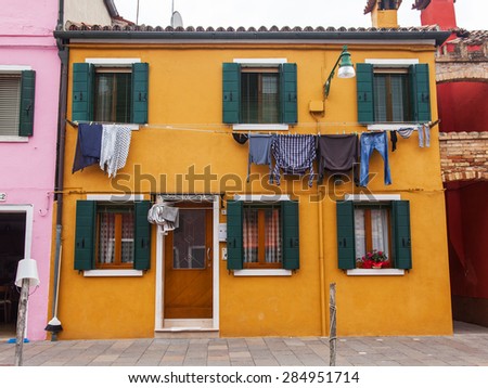 VENICE, ITALY, on APRIL 30, 2015. Architecture of multi-colored lodges of locals on Burano\'s island. Burano - one of islands of the Venetian lagoon