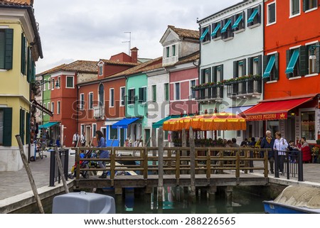 VENICE, ITALY - on APRIL 30, 2015. Burano the island, the street canal, the bridge through the canal and multi-colored houses on the embankment.
