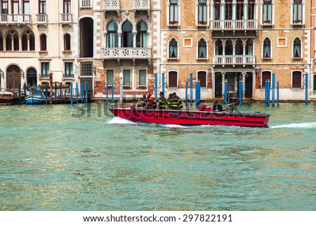 VENICE, ITALY - on MAY 3, 2015. City landscape. View of the coast of the Grand channel (Canal Grande) and typical architectural complex. The fire boat floats on the channel